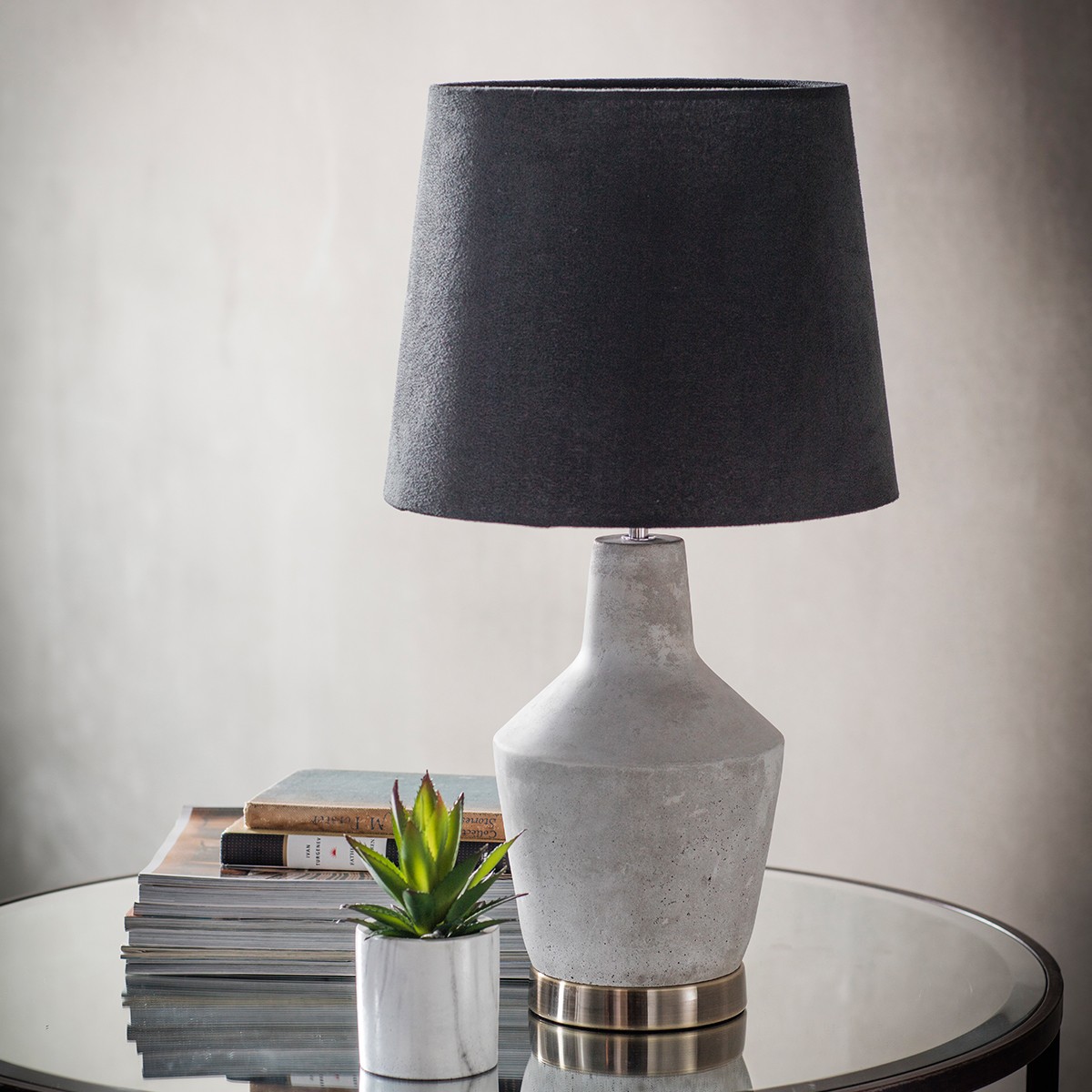 Stone effect table lamp with a black shade